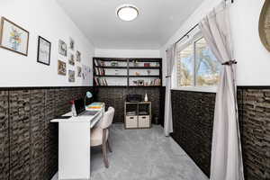 Carpeted office featuring built in desk