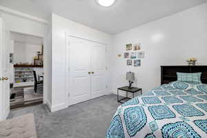 Carpeted bedroom with a closet