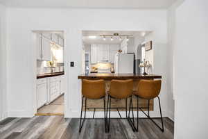 Kitchen featuring tasteful backsplash, sink, white appliances, and white cabinets