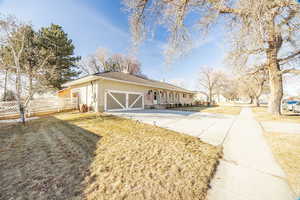 View of front of house featuring a garage and a front yard