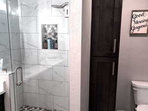 Bathroom featuring walk in shower, vanity, toilet, and hardwood / wood-style floors