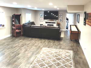 Living room with dark hardwood / wood-style flooring