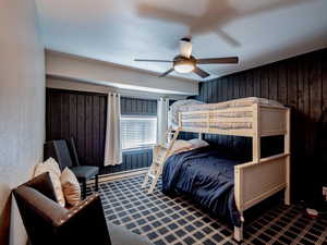 Bedroom with bunkbed that sleeps up to 3 people, ceiling fan and carpet flooring