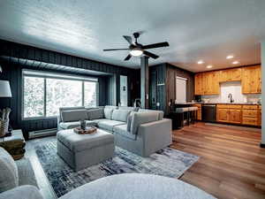 Living room with baseboard heater, breakfast bar and kitchen