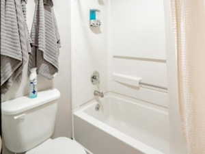 Master bathroom featuring shower / bath combo with shower curtain and toilet