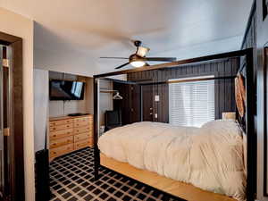 Master bedroom featuring ceiling fan and exterior door to the back side