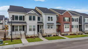 View of front of home with a front yard and central air condition unit