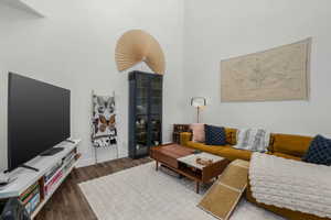 Living room with a high ceiling and dark hardwood / wood-style floors