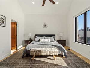 Bedroom featuring hardwood / wood-style floors, vaulted ceiling, and ceiling fan