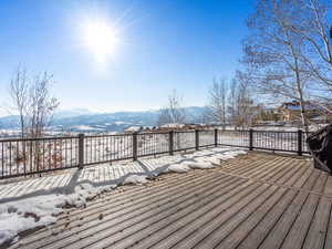 Snow covered deck with a mountain view