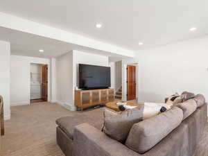 Carpeted living room featuring washer / clothes dryer