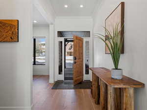 Foyer featuring crown molding and wood-type flooring