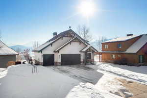 View of front of house with a garage and a mountain view