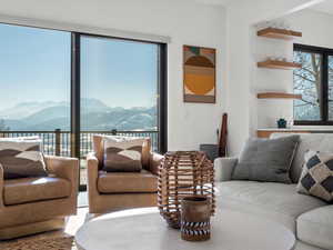 Living room with tile patterned flooring and a mountain view