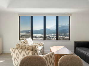 Sitting room featuring a mountain view and light carpet