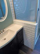 Bathroom featuring vanity and wood-type flooring