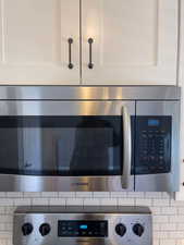 Room details with tasteful backsplash and wall oven