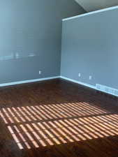 Unfurnished room featuring dark hardwood / wood-style flooring