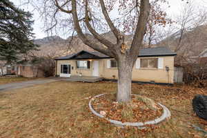 Ranch-style home with a mountain view and a front yard