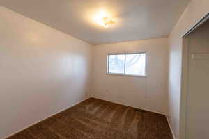 Empty room featuring carpet floors