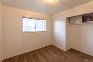 Unfurnished bedroom with a closet and carpet