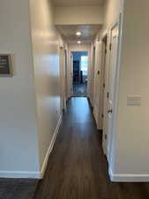 Corridor featuring dark hardwood / wood-style floors