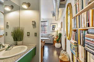 Bathroom featuring hardwood / wood-style flooring and vanity