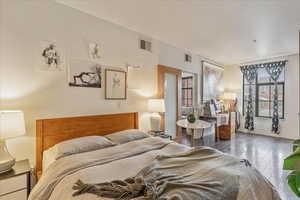 Bedroom with dark hardwood / wood-style floors