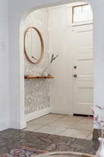 Foyer entrance featuring tile patterned flooring