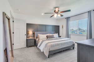 Bedroom featuring ceiling fan and light carpet