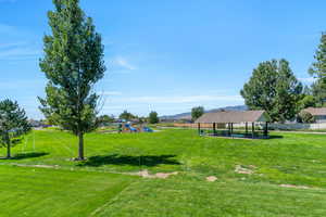 View of community with a playground, a gazebo, and a yard