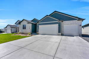 View of front facade with a garage and a front lawn