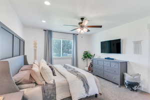 Bedroom featuring ceiling fan and light carpet