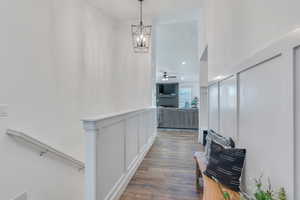 Hall with dark hardwood / wood-style flooring