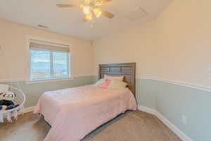 Bedroom featuring ceiling fan and carpet flooring