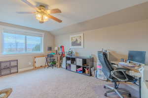 Office area with vaulted ceiling, carpet flooring, and ceiling fan