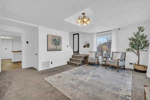 Sitting room featuring carpet and a chandelier