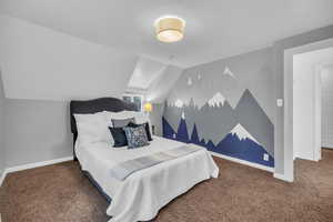 Carpeted bedroom featuring lofted ceiling