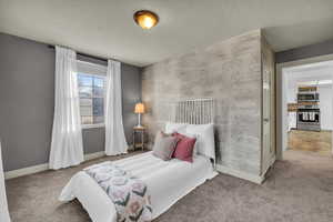 Bedroom featuring a textured ceiling and carpet flooring