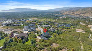 Aerial view of property's location featuring a mountainous background and nearby suburban area