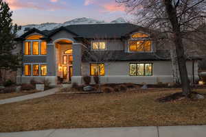 View of front of house featuring a mountain view and a lawn