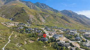 Aerial view of property and surrounding area with mountains and nearby suburban area