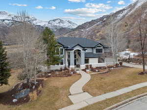 View of front of property with a mountain view and a front yard