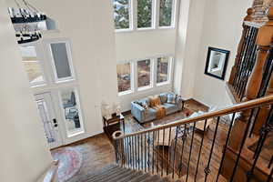 Interior space with a towering ceiling and dark hardwood / wood-style flooring