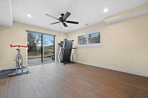 Exercise room featuring wood-type flooring and ceiling fan