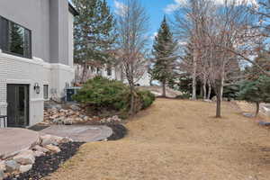 View of yard with cooling unit and a patio area