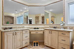 Bathroom with vanity, tile patterned flooring, and a wealth of natural light