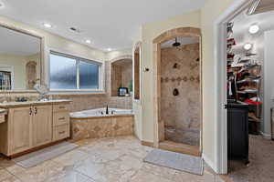 Bathroom with vanity and separate shower and tub