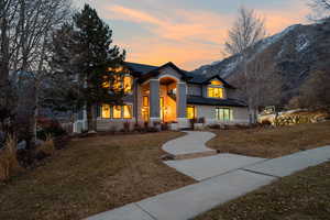 View of front of property with a yard and a mountain view