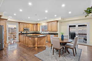 Kitchen featuring dark wood-type flooring, stainless steel appliances, french doors, and a healthy amount of sunlight